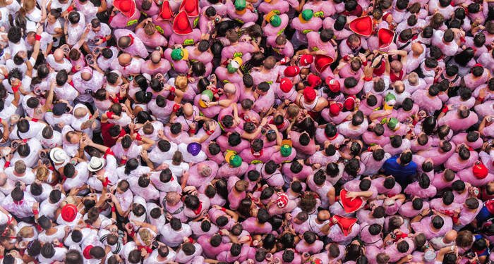 spain-pamplona-people-above-pink-cover