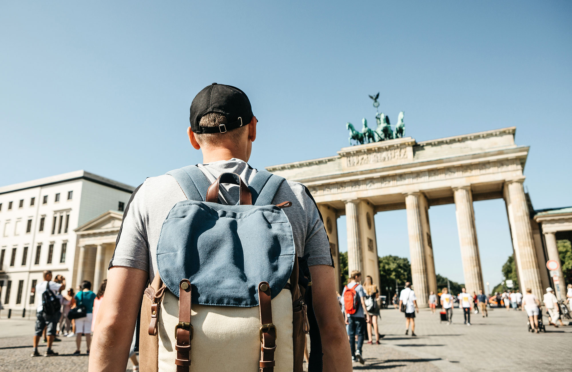 germany-berlin-guy-student-standing-brandenburg-gate