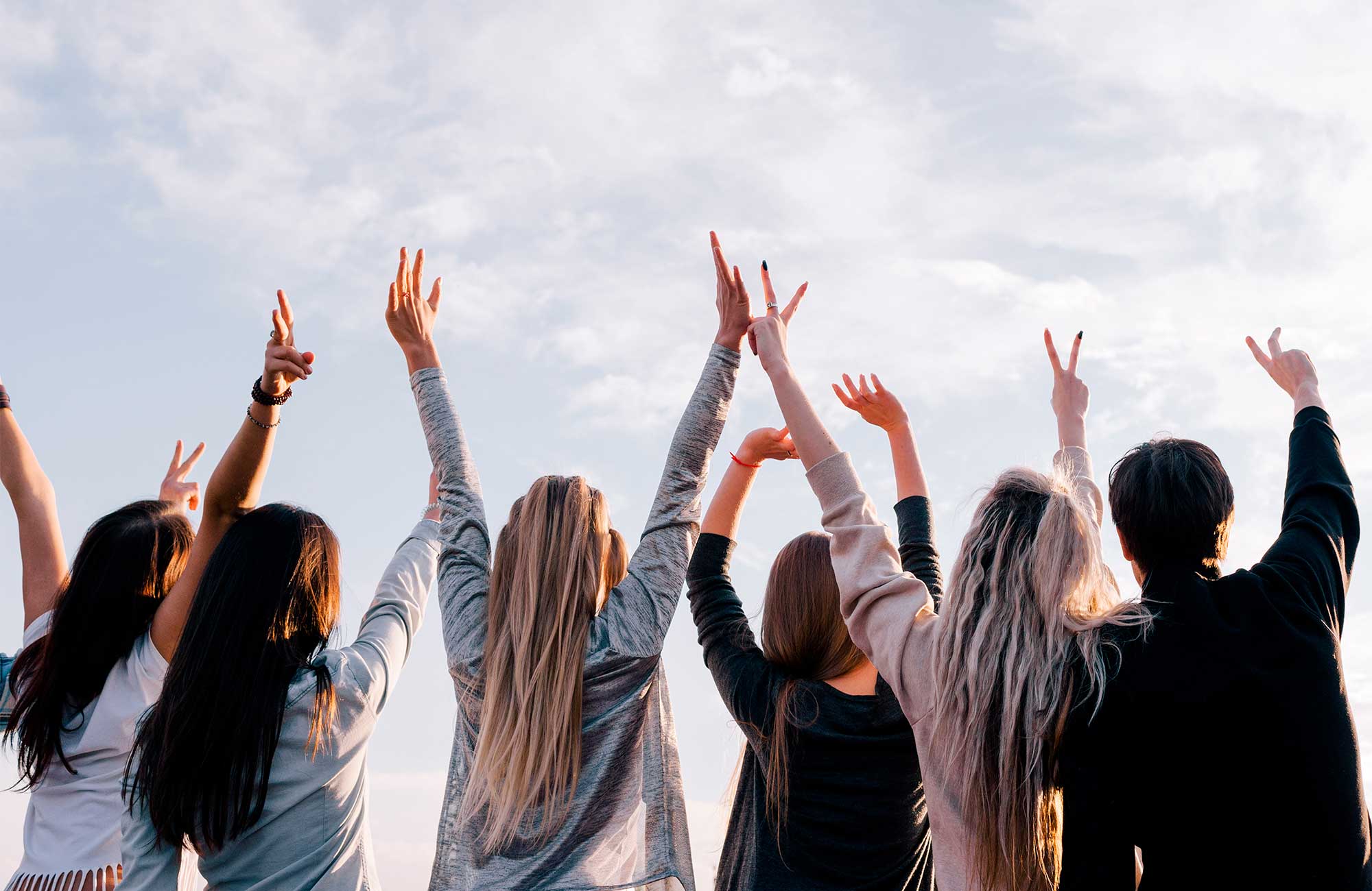 friends-student-group-reaching-sky-backside