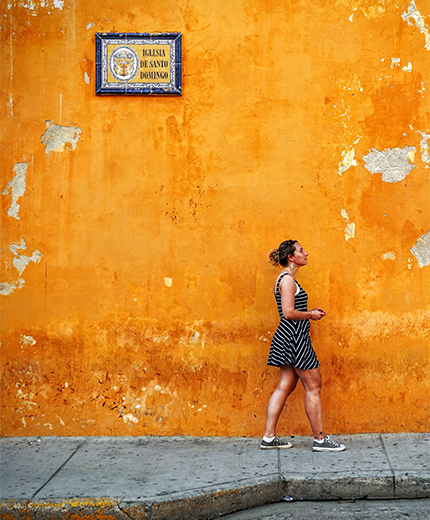 cartagena-colombia-girl-in-front-of-orange-wall-sidebar